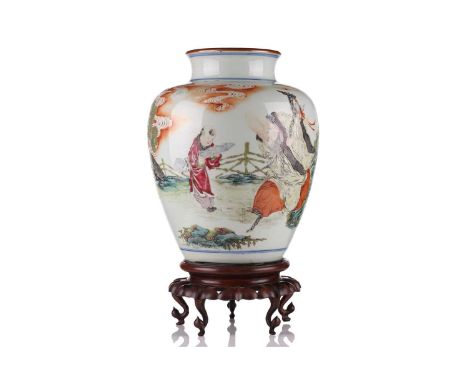 A Chinese porcelain vase, late Qing dynasty, painted with Shoulao and a boy attendant within a fenced garden, beneath red clo