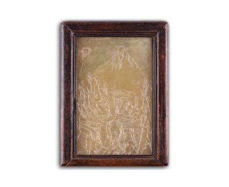 A Chinese jade plaque, Qing dynasty, 18th century, carved with lotus leaves below a mountain and the sun, within a hardwood f