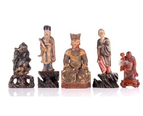 A Chinese carved wood and lacquered seated Emperor, Ming/Qing, wearing a relief moulded dragon robe, his right leg raised to 