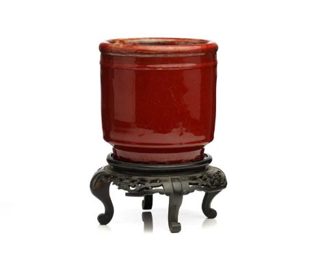 A Chinese sang de boeuf glazed planter, of cylindrical form with a narrow moulded band beneath the rim, the glaze a uniform c