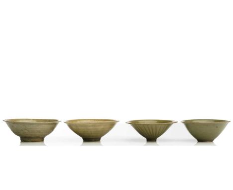 A Chinese Longquan celadon bowl, Song - Yuan dynasty, of shallow conical form, with flower head decoration, 11.3cm dia; a sim
