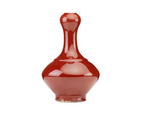 A Chinese sang de boeuf glazed vase, Suantouping, with garlic shaped mouth above a compressed body, the glaze a uniform colou