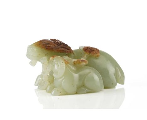 A Chinese jade figure of a ram and its young, in a recumbent pose, each sharing a single stem of lingzhi, the stone pale gree