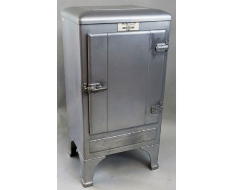 A 1930's General Motors Frigidaire drinks or music cabinet, adapted from a refrigerator, the steel casing with later silvered