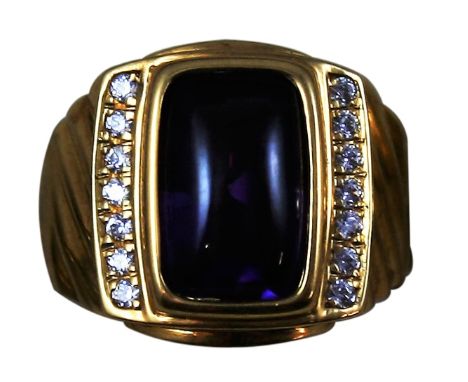 An 18 k gold, amethyst and diamond dress ring, collet set with a cabochon stone flanked by brilliant cut diamond set shoulder