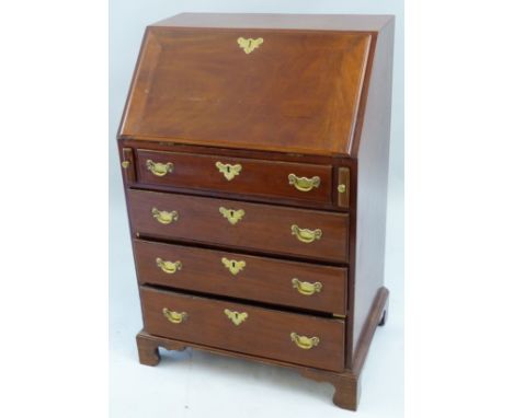 A Georgian mahogany small bureau, the fall front opening to reveal a fitted interior with inset writing surface, drawers, pig