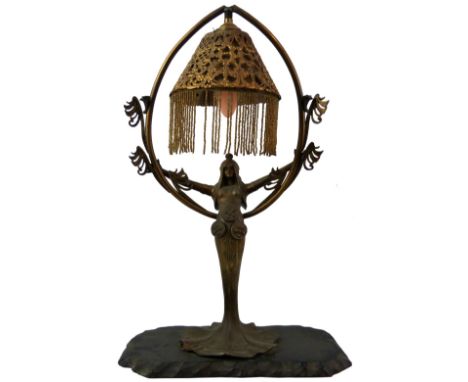 A French Art Nouveau bronzed spelter table lamp, entitled "Le Genie du feu", depicting a maiden in a long flowing dress with 