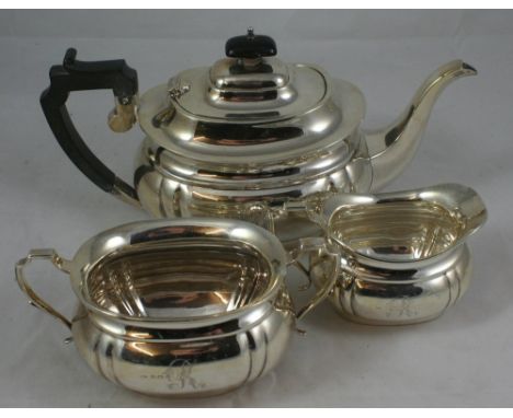 A silver three piece tea service, Birmingham 1932, of baluster form with lobed corners, comprising tea pot, sugar bowl and mi