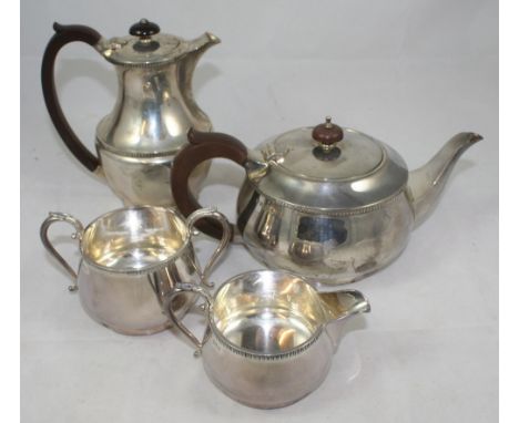 A silver four piece tea and coffee service, Birmingham 1960, of baluster form with a gadrooned border, raised on a spreading 