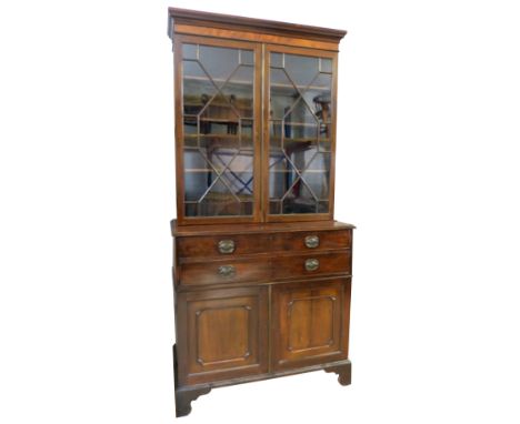 A 19th century mahogany secretaire bookcase, with dentil cornice over a plain frieze and two astragal glazed doors enclosing 