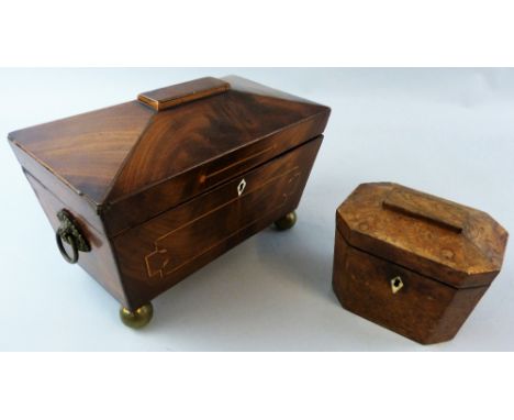 A 19th century mahogany tea caddy, of sarcophagus form with inlaid stringing, embossed brass "basket of flowers" ring handles