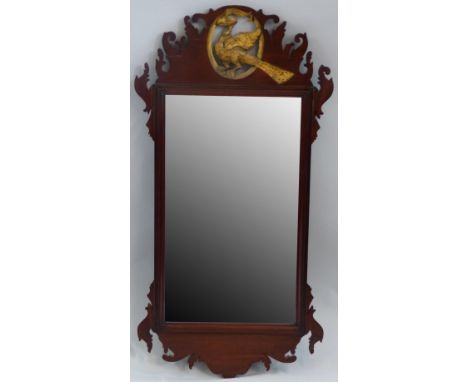 An early 20th century Chippendale style fretworked mahogany wall mirror, with gilded carved and pierced ho-ho bird to the top