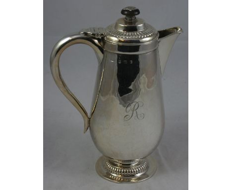 A. E. Jones - a silver coffee/hot water pot, London 1913, of baluster form raised on a fluted pedestal base, ebony finial, in