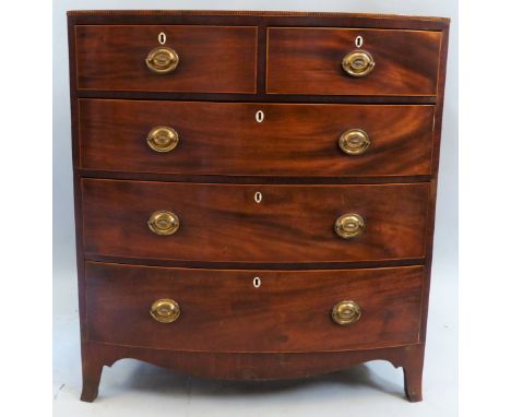 A George III mahogany bow-fronted chest, of two short and three long graduated drawers with boxwood edging and embossed brass