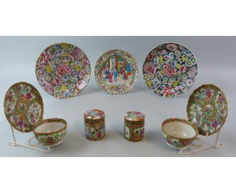 A pair of 19th century Cantonese boxes and covers, each of cylindrical form painted in the Famille Rose palette with panels o