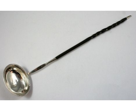 A George III silver and whalebone toddy ladle, makers mark worn, London 1808, the oval bowl with reeded border and bright cut
