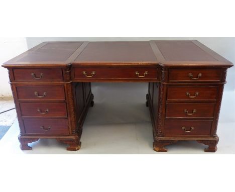 A mahogany partners desk, second half of the 20th century in the Victorian style, of inverted breakfront form with three inse
