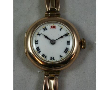 A 9ct rose gold ladies manual wind wristwatch, London 1920, the white enamel dial with black Roman numerals, red 12, the 15 j