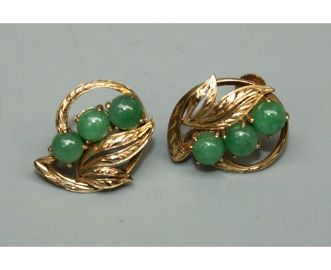 A pair of jade set 14ct gold earrings, open leaf form, each set with three round cabochon jade stones, size approx 17mm, stam