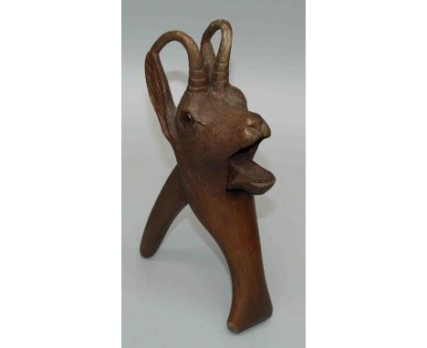 A Black Forest carved wood nutcracker in the form of a mountain goat fitted with glass eyes, minor damage, height 21cm