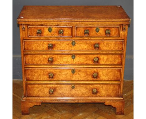 A George II style figured walnut veneered bachelor's chest, the rectangular folding top over bearers, two short and four long