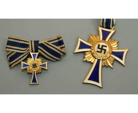 A Third Reich Mother's cross in gilt metal and blue and white enamel inscribed to verso 16 December 1938, together with the m