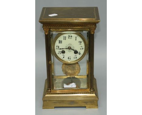 A late 19th century French brass four glass mantle clock, The Corinthian column case enclosing an eight day bell striking mov