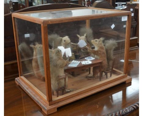 Taxidermy. In the manner of Walter Potter. Victorian group of taxidermy squirrels playing cards, in a later glass case.