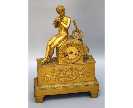 A 19th century French brass and ormulu mantle clock, the surmount of seated boy with flute beside a drum, case enclosing an e