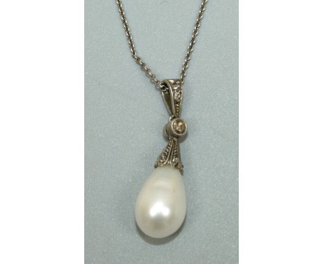 A cultured pearl and white gold pendant, comprising a pear shaped white pearl, approx 12 x 8mm, with a grain set diamond top 