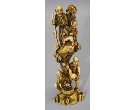 A Japanese Meiji period ivory netsuke of unusual proportions, carved with a huntsman and dog on a rocky precipice, other figu