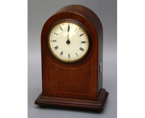 An Edwardian mahogany and strung mantle timepiece, the dome case enclosing an eight day movement, faced by Roman enamel dial,