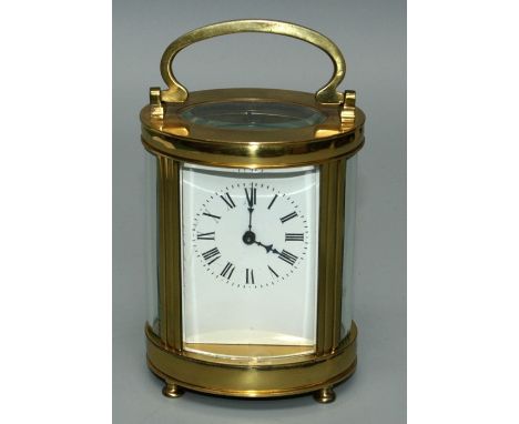 A 20th century brass five glass carriage clock, the oval case enclosing an eight day movement, faced by enamel Roman dial, on