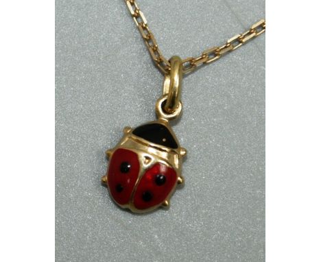 An enamel and 18ct gold pendant in the form of a lady bird, size approx 6mm, stamped 750,  on a fine link chain, length appro