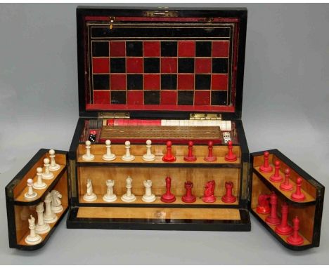 A Victorian Coromandal games compendium, the rising top opening to reveal a fitted interior with front opening panels reveali