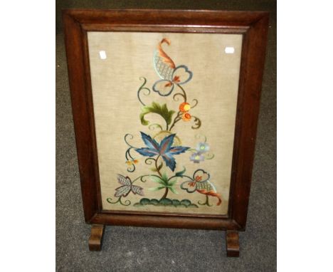 A mid 19th century crewelwork of an imagining blossoming tree, set in an oak firescreen frame, 93 x 63cm