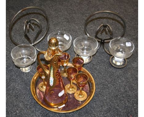 A Venetian pink glass, gilded and enamel liqueur set and a pair of twin glass candle holders with steel wall brackets