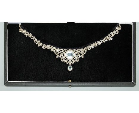 An Edwardian style aquamarine and rose cut diamond necklace, comprising a central oval aquamarine weighing approx 8.62carats,