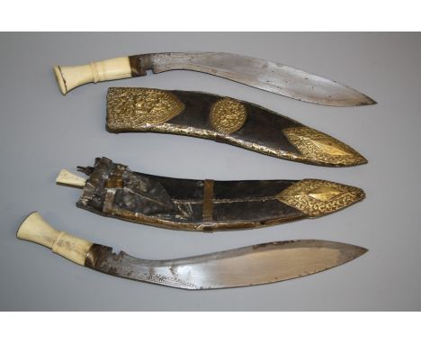 Two similar Indian kukri, circa 1900, each with carved bone handle, swollen single edge steel blade in brass mounted leather 