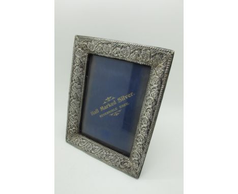 A Hallmarked Silver Mounted Rectangular Photograph Frame, detailed in relief, on plush 'reversible' easel back (allowing to s