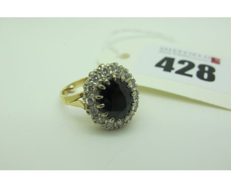 An 18ct Gold Sapphire and Diamond Oval Cluster Ring, claw set to the centre within border of brilliant cut stones (approximat