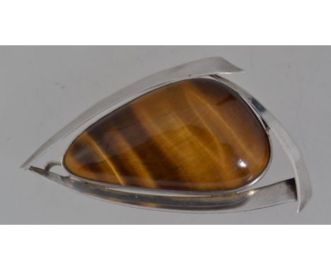 A vintage / mid century modern marked silver pendant brooch set with a large tigers eye stone with roller clip clasp and pend