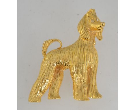 A vintage gold tone figural brooch in the form of an Afghan Hound dog with rhinestone eyes and roller clip clasp. Measures 6 