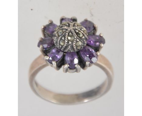 A vintage 925 silver ring set with amethyst and marcasite in a domed flower cluster setting. Marked 925. Size P. Weight 7.2g.