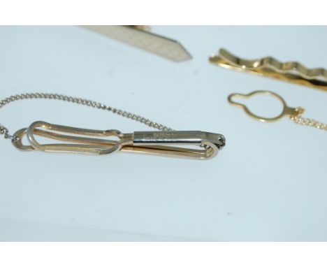 A pair of vintage  yellow metal shirt cuffs together with three yellow metal tie clips and a pair of cufflinks.