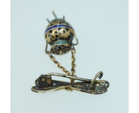 A vintage yellow metal filigree and enamel brooch with drop caldron pendant with c clasp. Mark to pin. Measures 2.5cms. Weigh