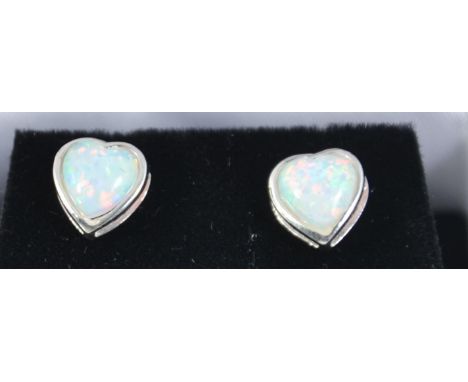 A pair of silver and heart shaped ladies opal earrings - studs complete in the presentation box.