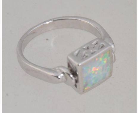 A ladies decorative silver revolving opal and fret pierced dress ring. Total weight 4.2g / Size N