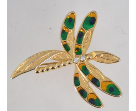 A vintage yellow metal enamelled figural brooch in the form of a dragonfly with bezel set rhinestone decoration and roller cl
