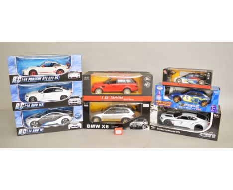 Eight boxed Radio-Control model cars, various marques including BMW, Porsche etc. in 1:14 and other scales. Generally appear 